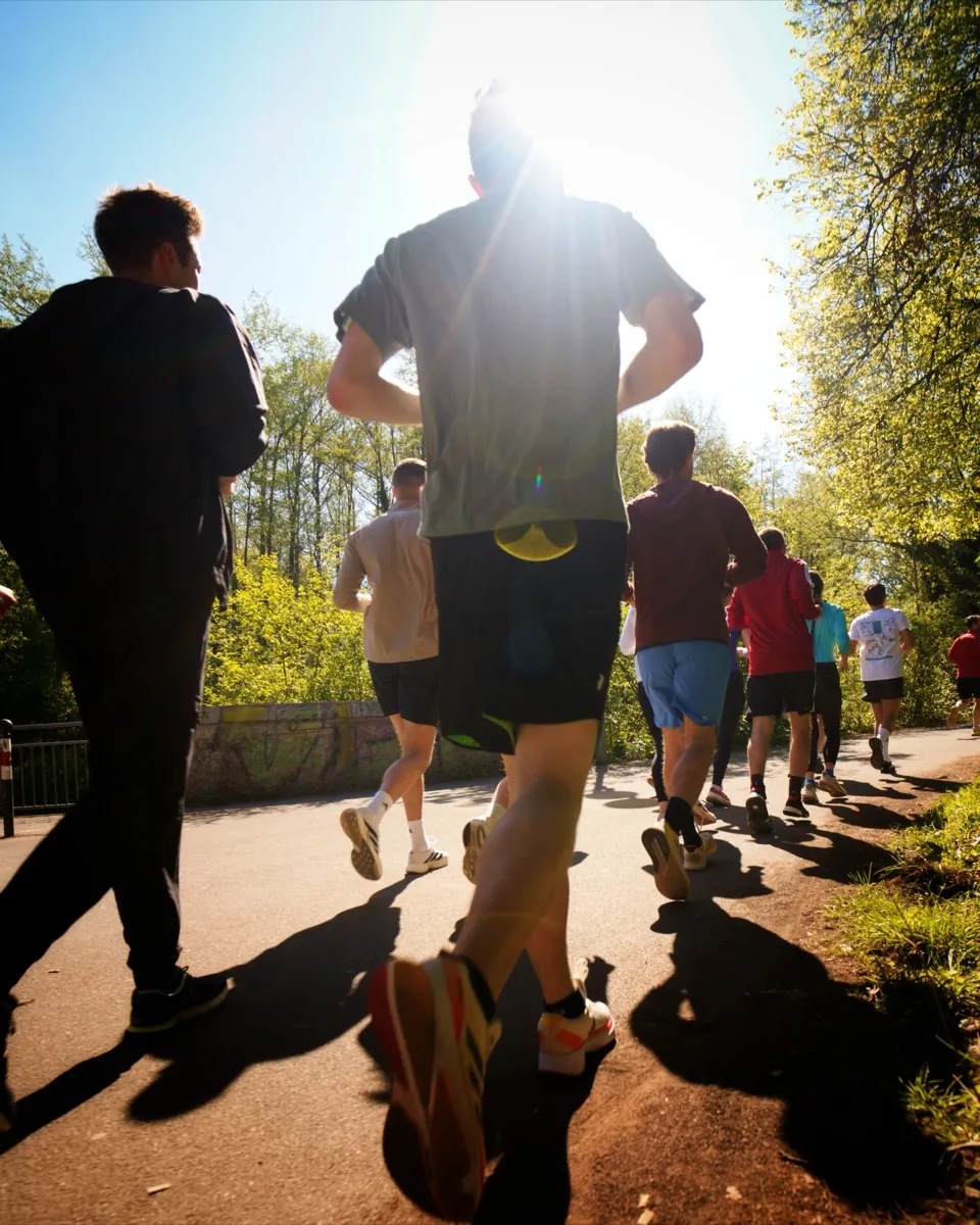 Runners backlit by the morning sun